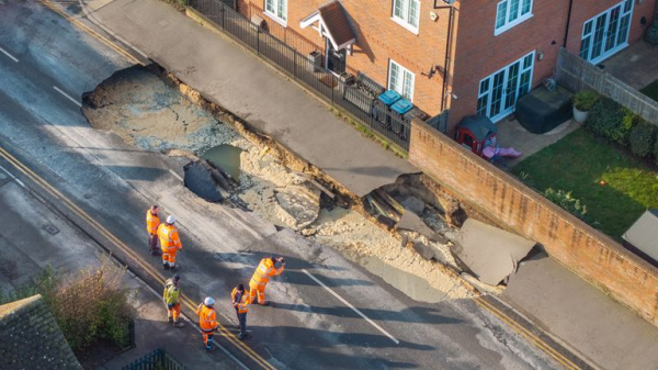 Large sinkhole forces closure of Godstone High Street in Surrey following burst water pipe